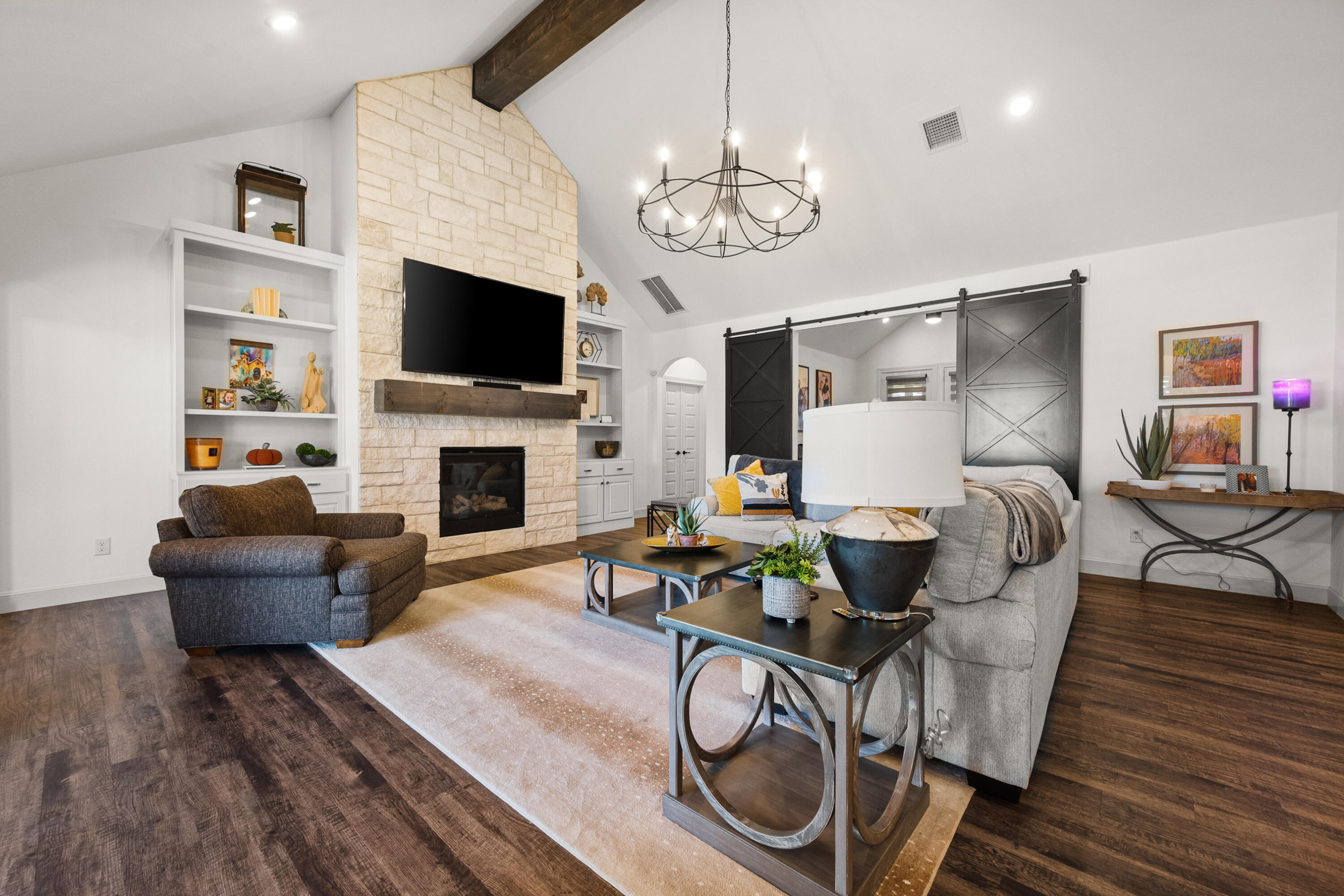 4509 140th Street Lubbock, TX 79424 - Photo 6 of 41 a living room with furniture a flat screen tv and a fireplace