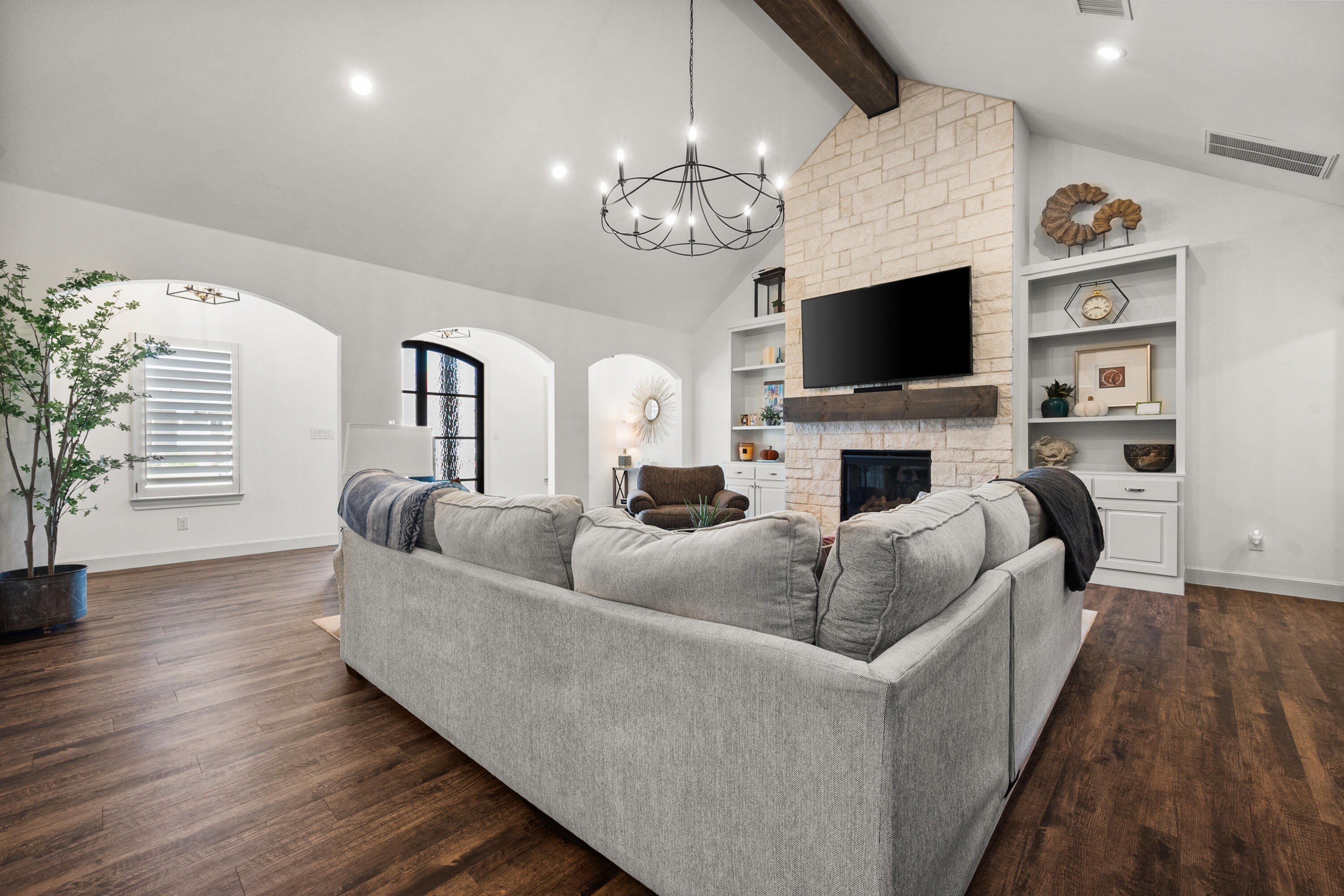 4509 140th Street Lubbock, TX 79424 - Photo 9 of 41 a living room with fireplace furniture and a flat screen tv