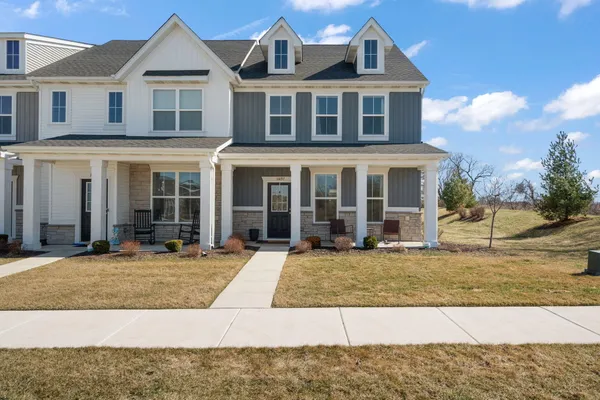 a front view of a house with swimming pool and porch