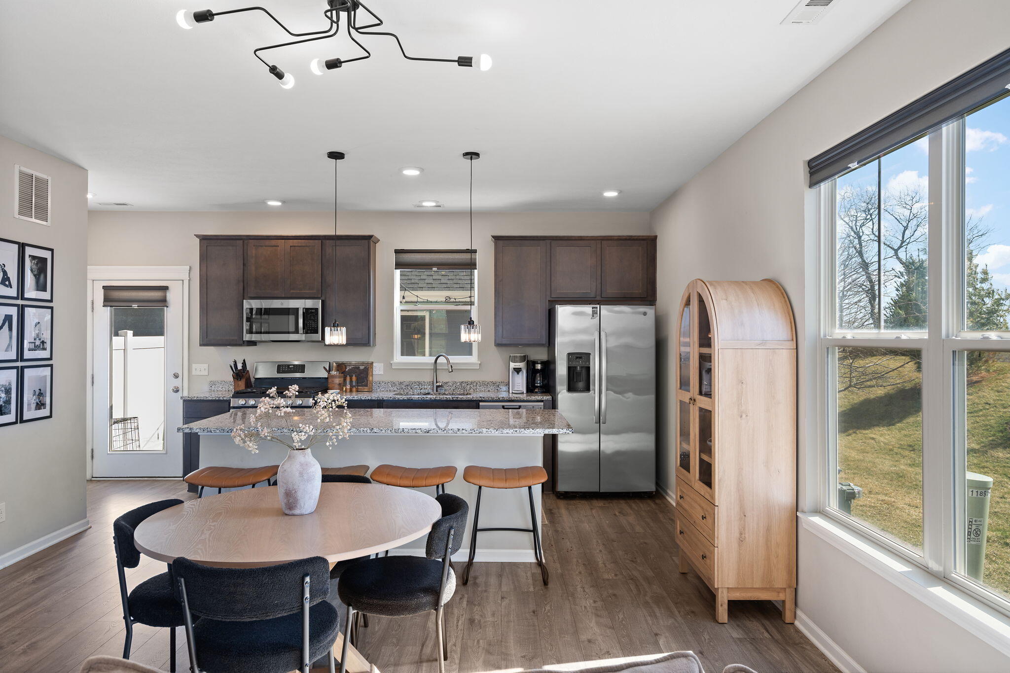 11897 Rhode Island Street Crown Point, IN 46307 - Photo 11 of 21 a kitchen with refrigerator and chairs