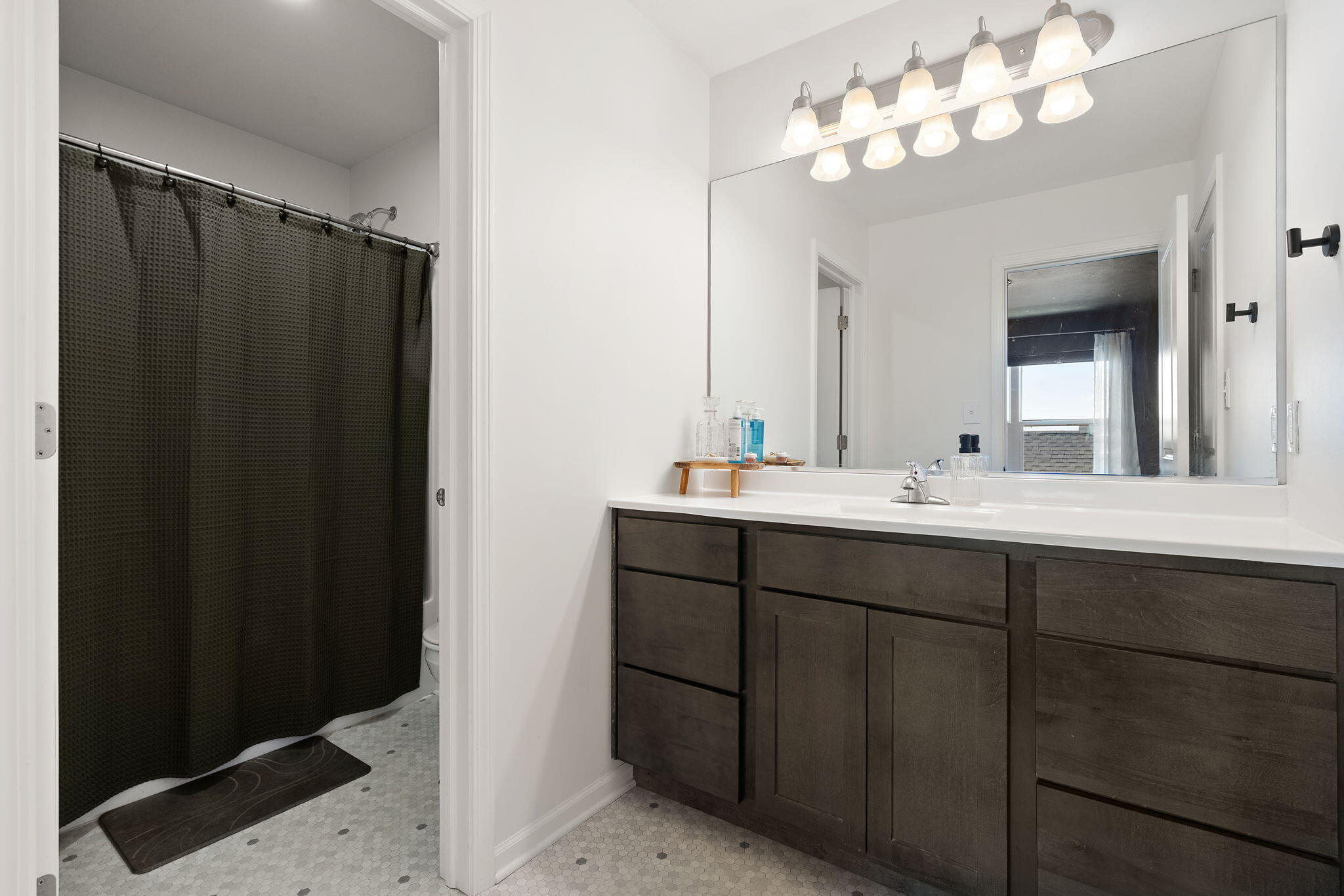 11897 Rhode Island Street Crown Point, IN 46307 - Photo 14 of 21 a bathroom with a sink vanity and a mirror