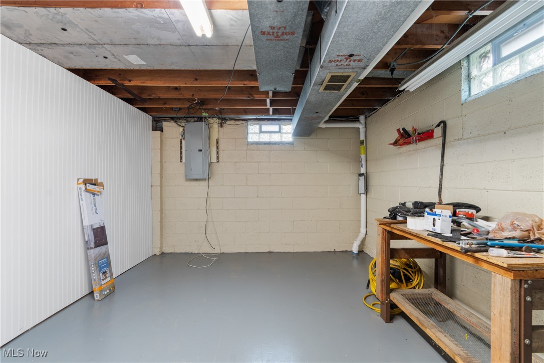 1067 Munroe Falls Kent Road Kent, OH 44240 - Photo 22 of 31 Basement featuring a workshop area and electric panel