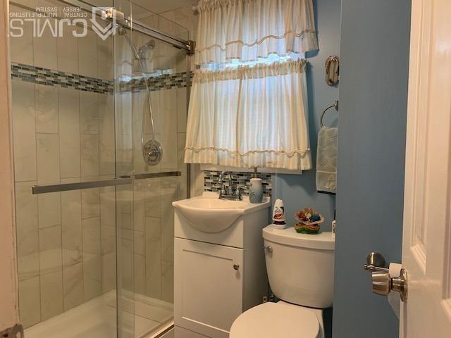 707 Spruce Road North Brunswick, NJ 08902 - Photo 11 of 23 a bathroom with a toilet sink vanity and shower
