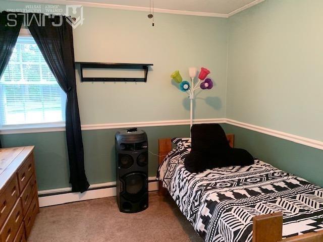 707 Spruce Road North Brunswick, NJ 08902 - Photo 13 of 23 a bed sitting in a bedroom next to a window