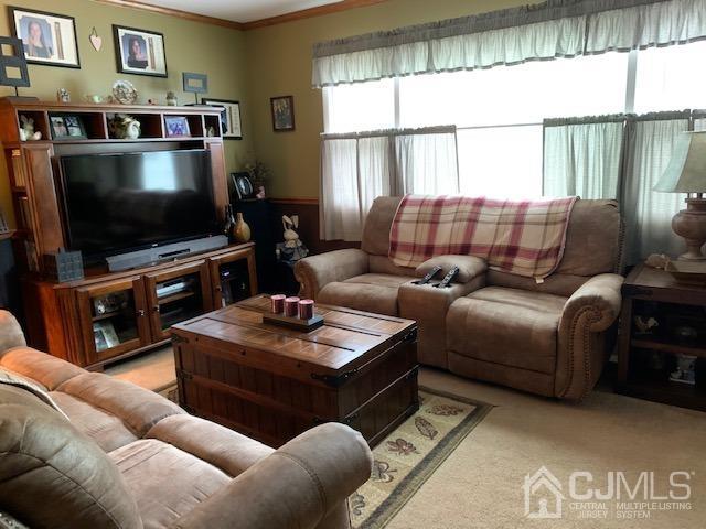 707 Spruce Road North Brunswick, NJ 08902 - Photo 14 of 23 a living room with furniture a flat screen tv and a floor to ceiling window