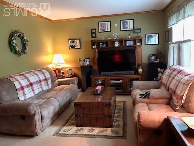 707 Spruce Road North Brunswick, NJ 08902 - Photo 15 of 23 a living room with furniture and a flat screen tv
