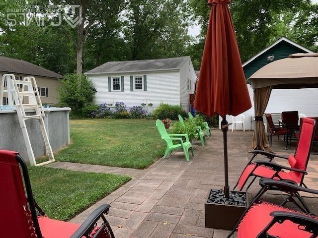 707 Spruce Road North Brunswick, NJ 08902 - Photo 20 of 23 a view of a backyard with furniture and a grill