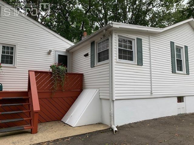 707 Spruce Road North Brunswick, NJ 08902 - Photo 23 of 23 a view of a house with a large window and wooden fence