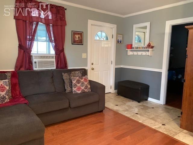 707 Spruce Road North Brunswick, NJ 08902 - Photo 5 of 23 a living room with furniture a flat screen tv and a fireplace
