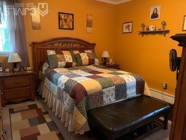707 Spruce Road North Brunswick, NJ 08902 - Photo 7 of 23 a bedroom with a bed and cabinets
