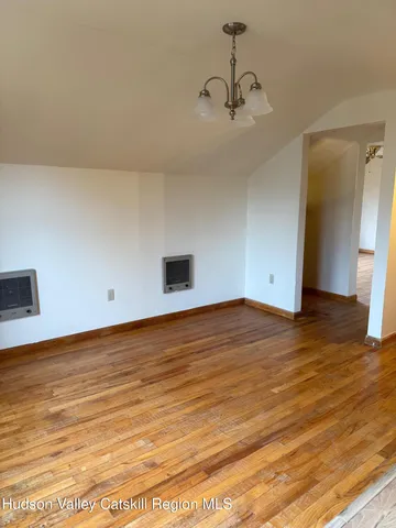 a view of an empty room and wooden floor