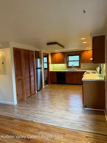 a view of a kitchen with a sink and a fireplace