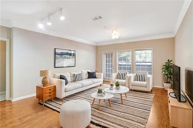 a living room with furniture and wooden floor