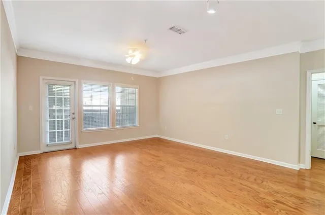 wooden floor in an empty room with a window