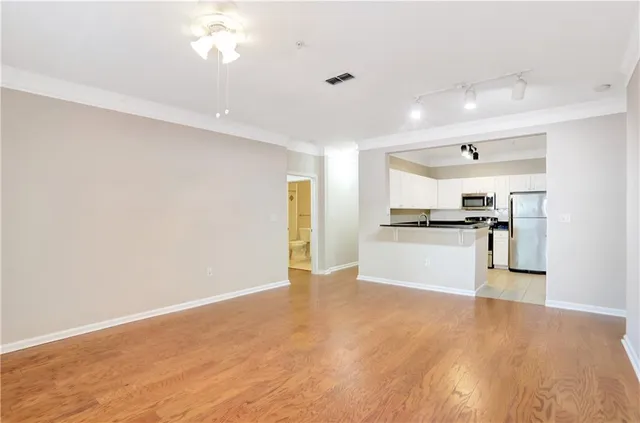 a kitchen with white cabinets and black appliances