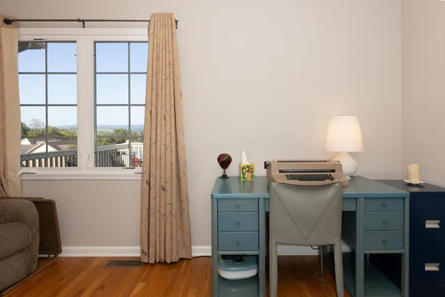 a bedroom with a bed a table and painting