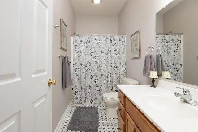a bathroom with a sink vanity and a mirror