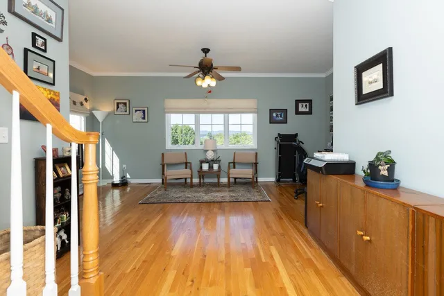 a view of a workspace with furniture and a window