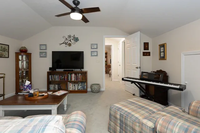 a bedroom with a bed and a flat tv screen on dresser