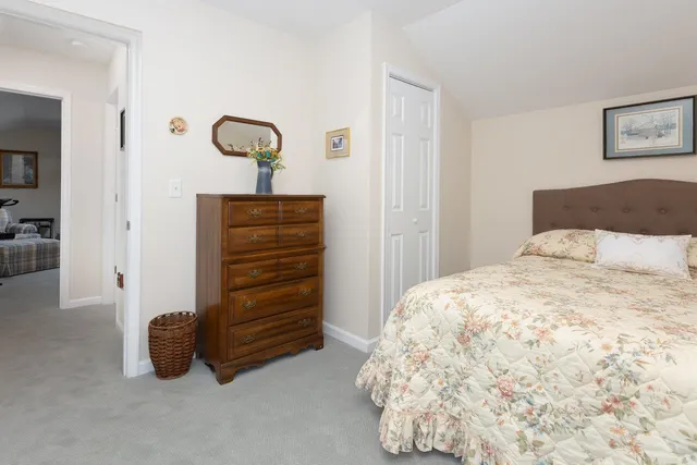 a bathroom with a granite countertop toilet sink and mirror
