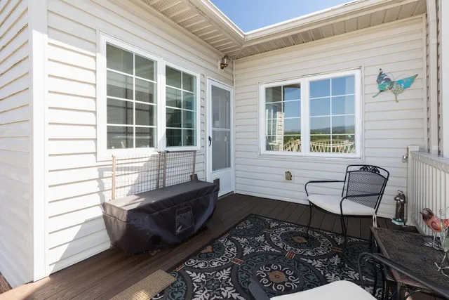 a view of a house with a yard and a large tree front of house