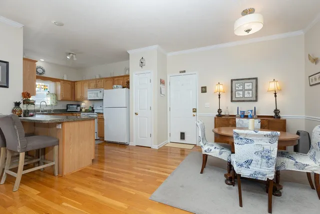 a living room with furniture and kitchen view