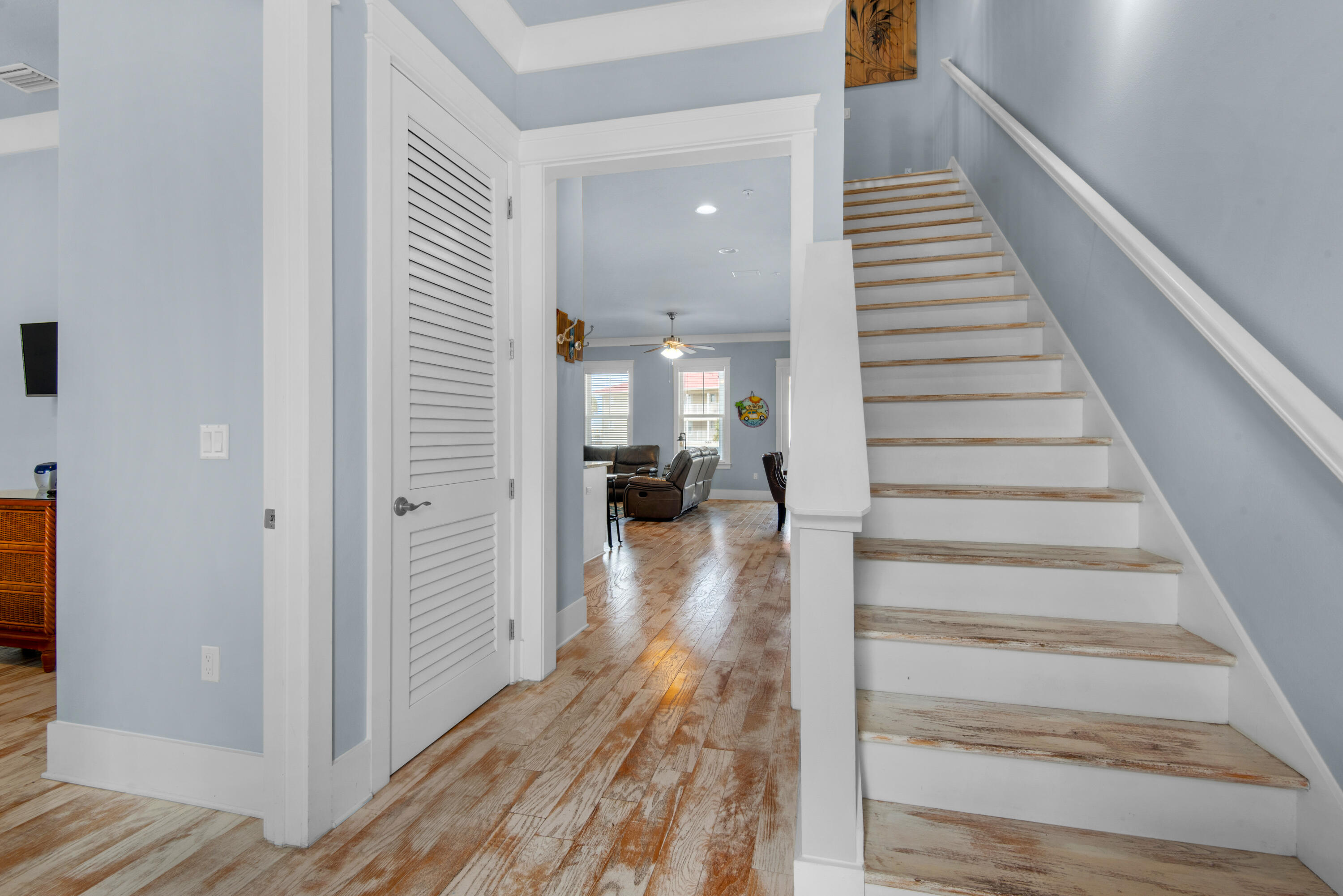 1494 Seaside Circle Navarre, FL 32566 - Photo 15 of 69 a view of a hallway with wooden floor and staircase