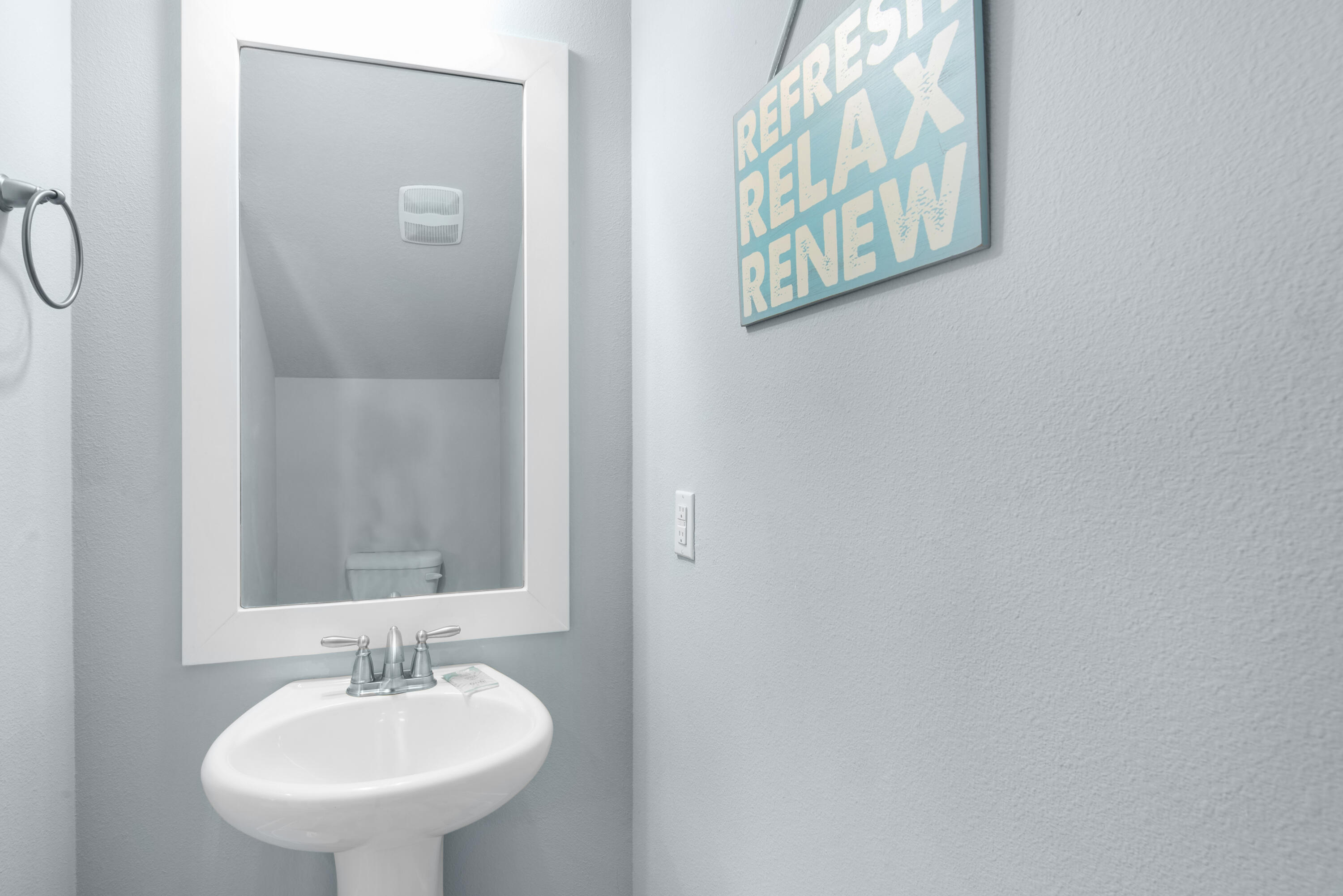 1494 Seaside Circle Navarre, FL 32566 - Photo 17 of 69 a bathroom with a sink and a mirror