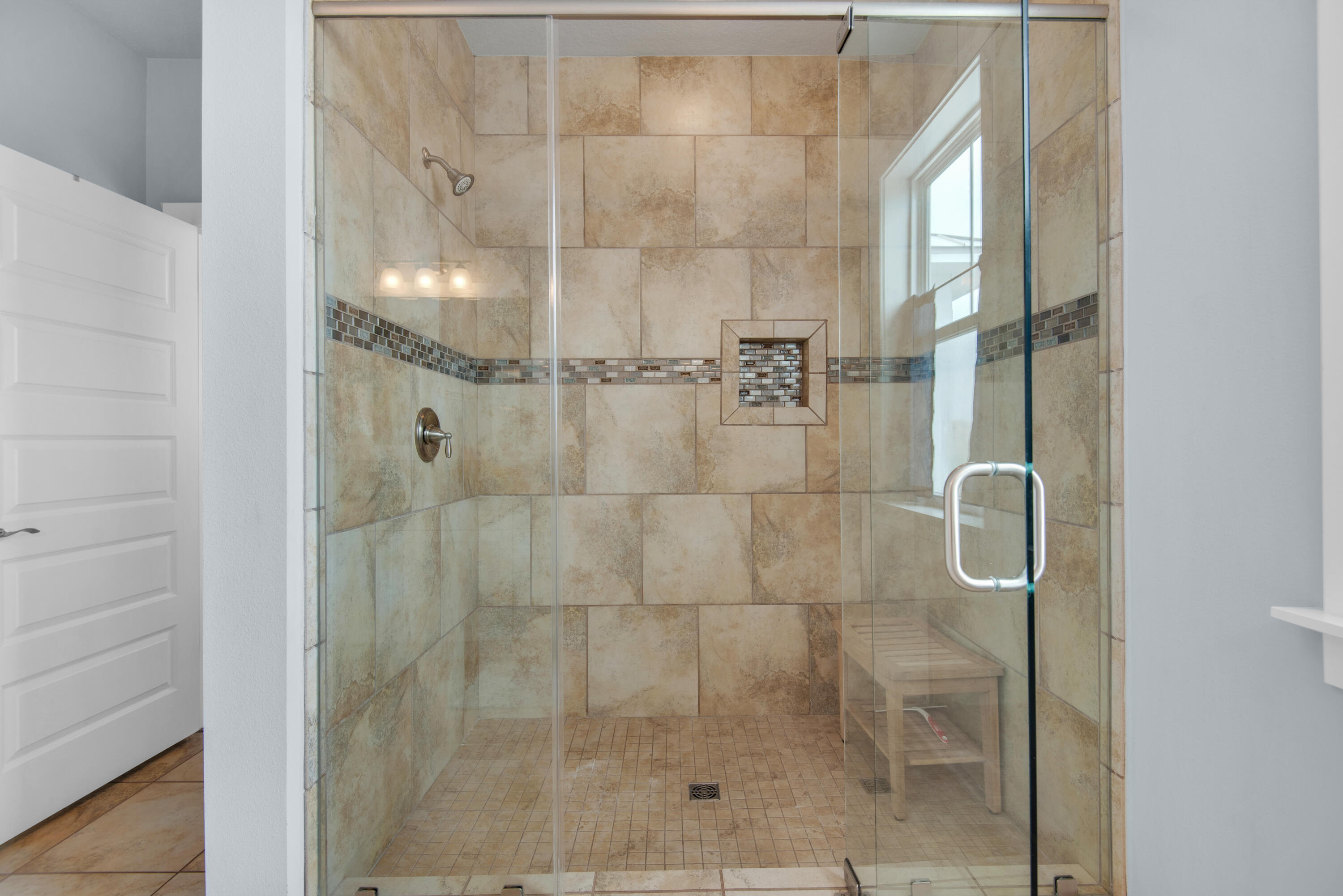 1494 Seaside Circle Navarre, FL 32566 - Photo 27 of 69 a bathroom with a glass shower door