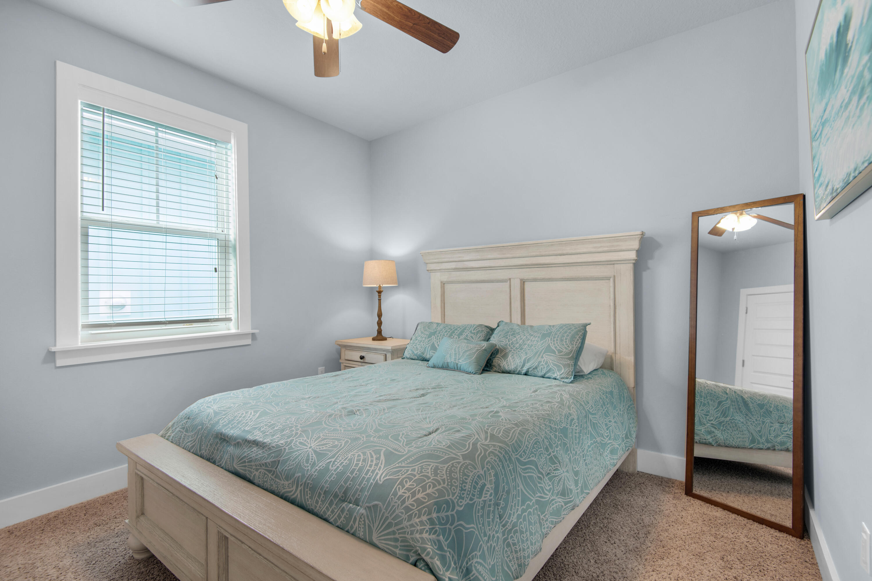 1494 Seaside Circle Navarre, FL 32566 - Photo 29 of 69 a bedroom with a large bed and a chandelier fan