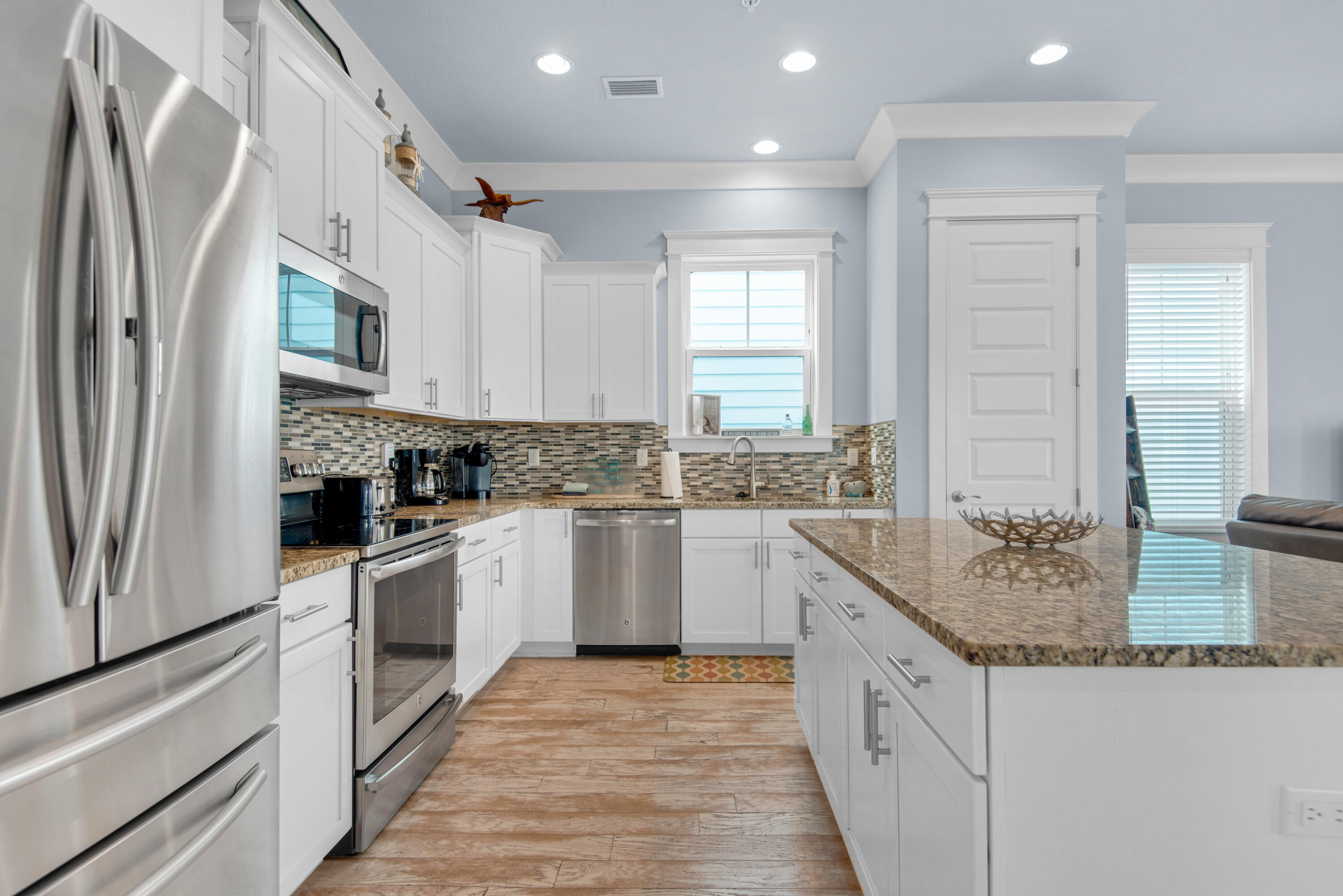 1494 Seaside Circle Navarre, FL 32566 - Photo 3 of 69 a kitchen with stainless steel appliances granite countertop a stove a sink and a refrigerator