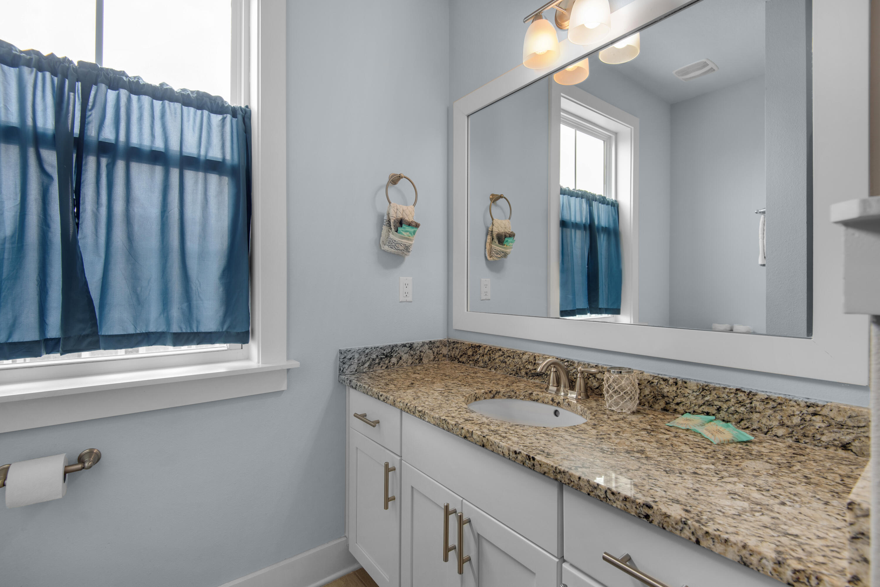 1494 Seaside Circle Navarre, FL 32566 - Photo 35 of 69 a bathroom with a granite countertop sink and a mirror