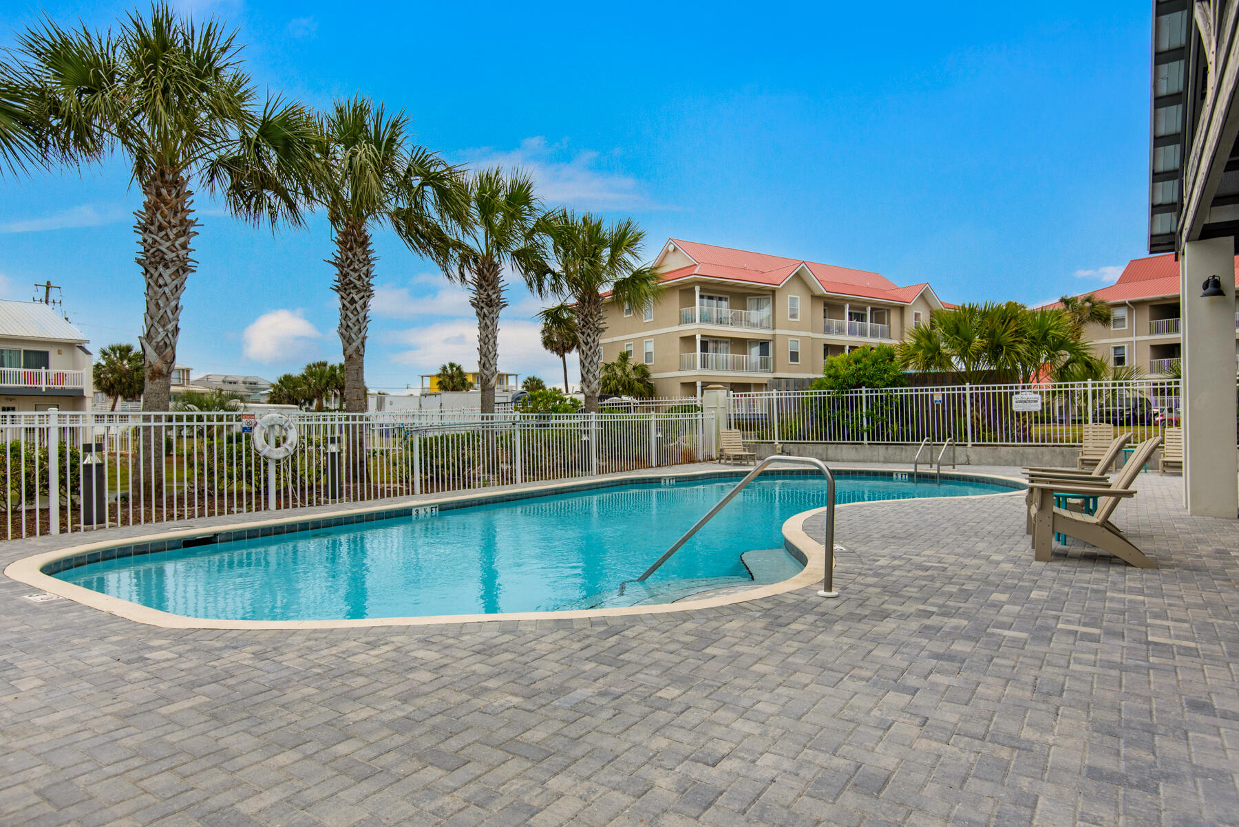 1494 Seaside Circle Navarre, FL 32566 - Photo 43 of 69 a view of a swimming pool with a lounge chair