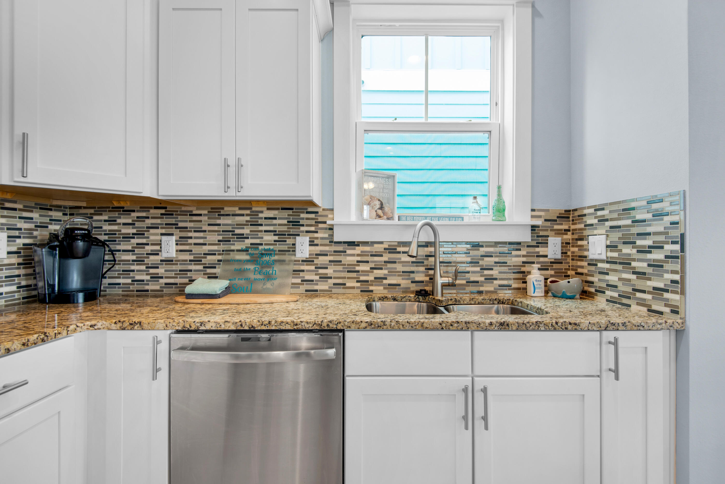 1494 Seaside Circle Navarre, FL 32566 - Photo 5 of 69 a kitchen with granite countertop sink and cabinets