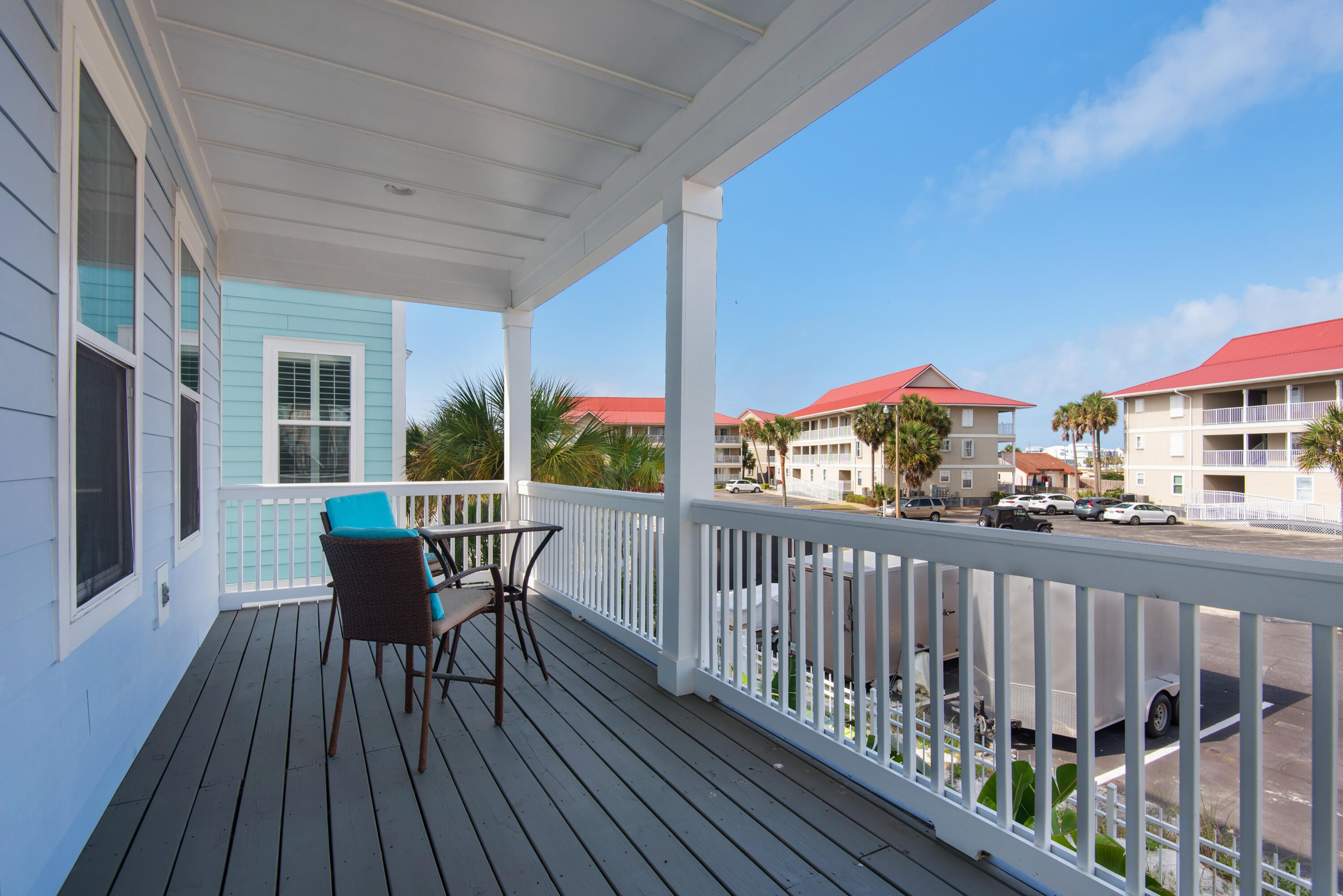 1494 Seaside Circle Navarre, FL 32566 - Photo 62 of 69 a view of a balcony with wooden floor and outdoor seating