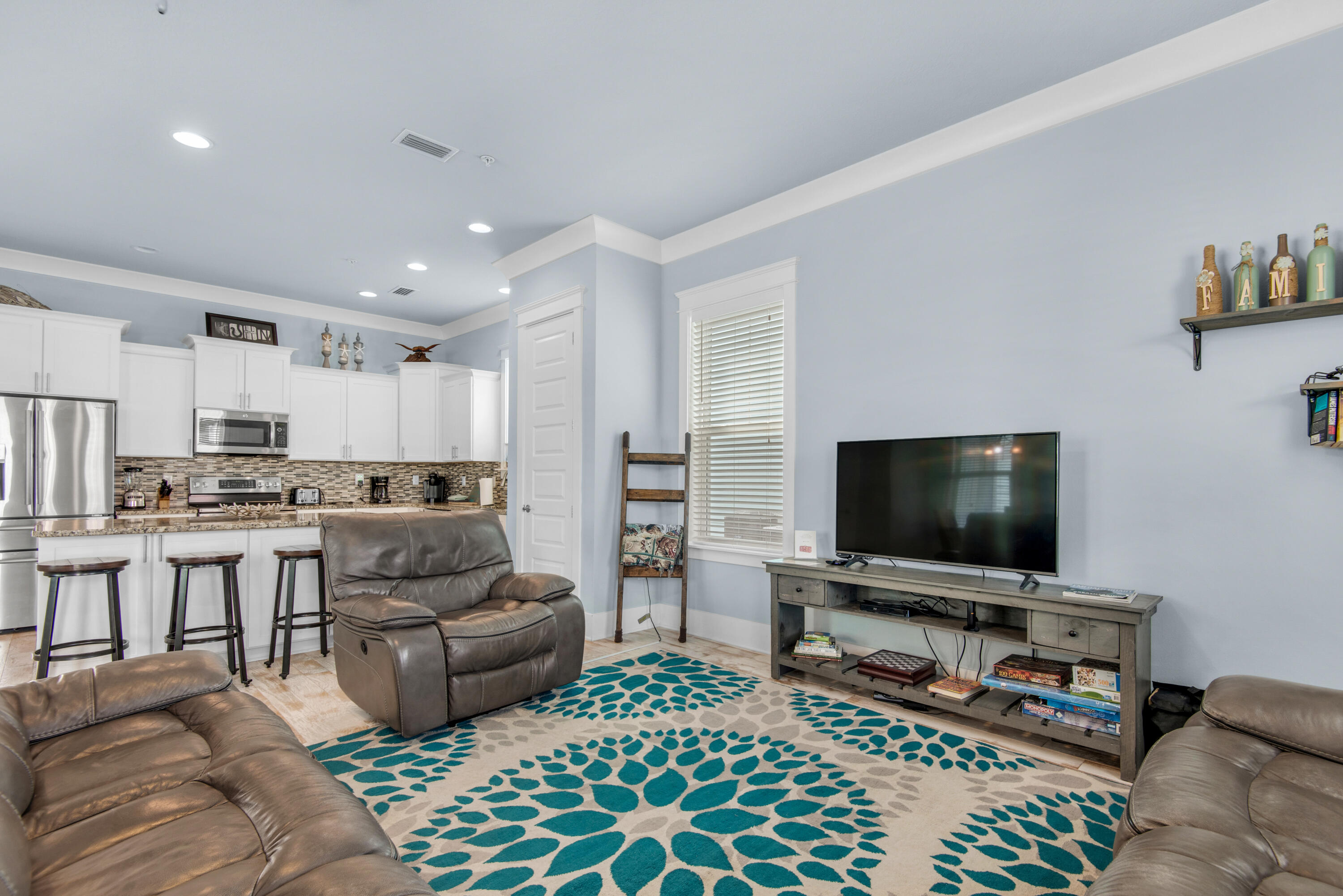 1494 Seaside Circle Navarre, FL 32566 - Photo 7 of 69 a living room with furniture and a flat screen tv