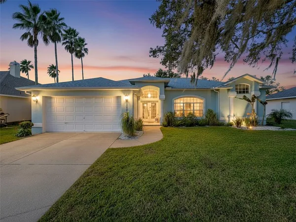 a front view of a house with a garden and yard