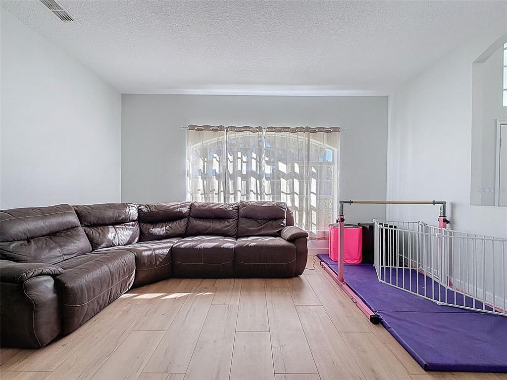 3365 Indian River Street Spring Hill, FL 34609 - Photo 13 of 38 a living room with furniture and a large window