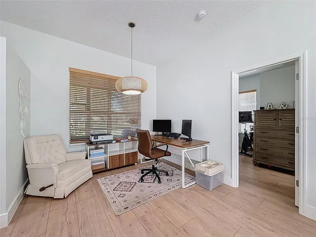 a living room with a couch and a chandelier