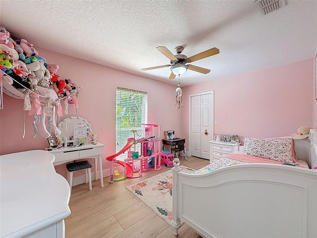 3365 Indian River Street Spring Hill, FL 34609 - Photo 21 of 38 a living room with a couch and a chandelier