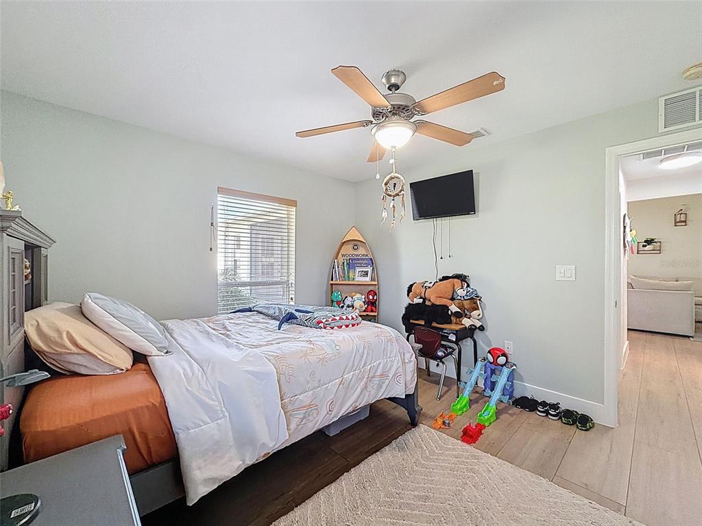 3365 Indian River Street Spring Hill, FL 34609 - Photo 24 of 38 a bedroom with a bed and a chandelier