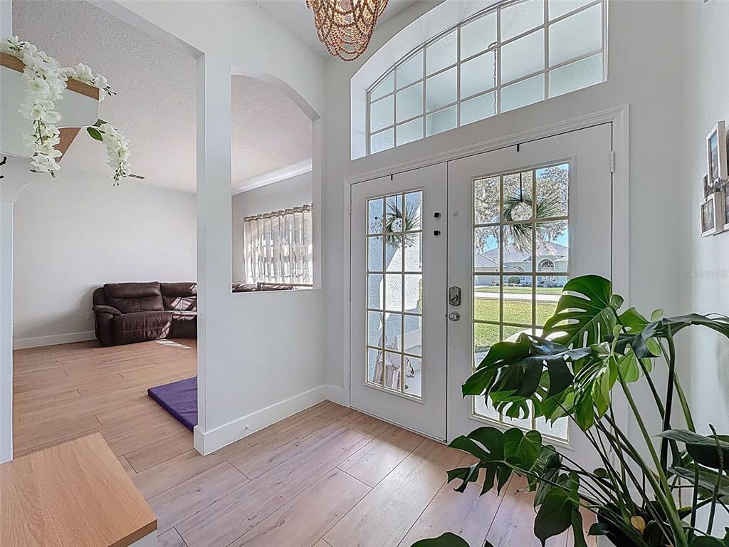 3365 Indian River Street Spring Hill, FL 34609 - Photo 4 of 38 a living room with furniture and a potted plant