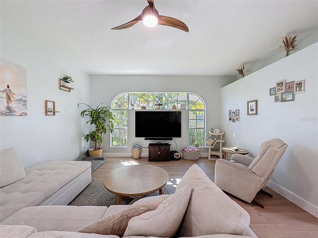 3365 Indian River Street Spring Hill, FL 34609 - Photo 7 of 38 a living room with furniture and a fireplace