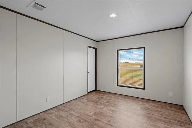 an empty room with windows and closet