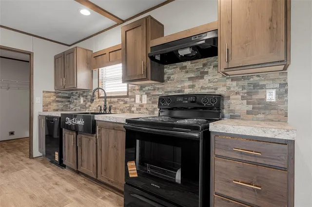 a kitchen with stainless steel appliances granite countertop a stove and a microwave