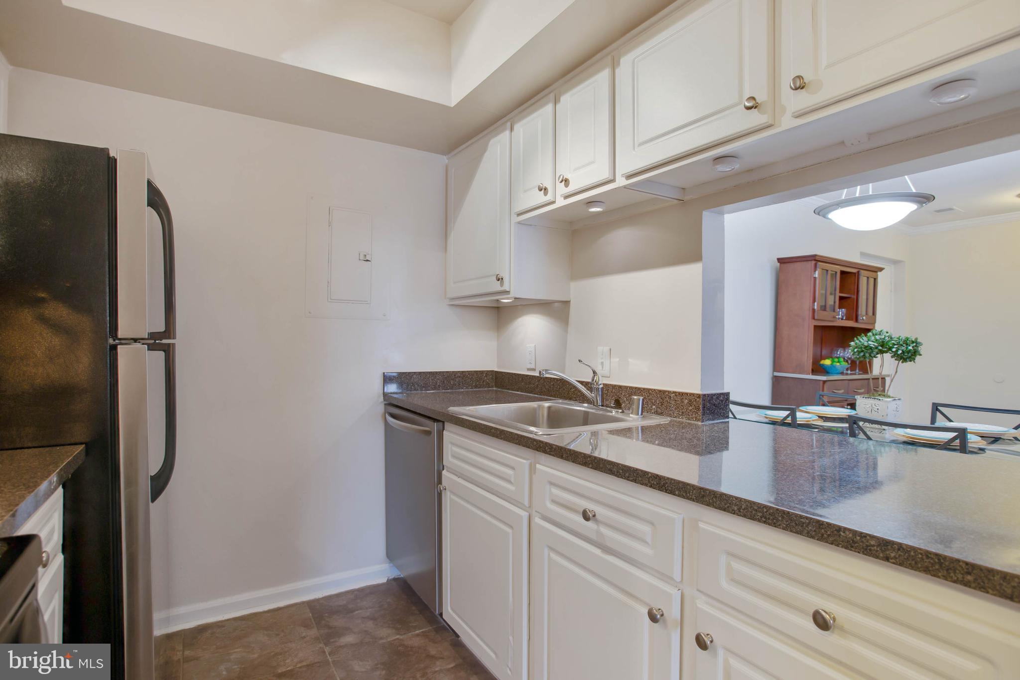 18318 Streamside Drive, Unit 203 Gaithersburg, MD 20879 - Photo 13 of 25 View of kitchen with pass through to dining room