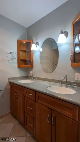 a bathroom with a double vanity sink and a mirror