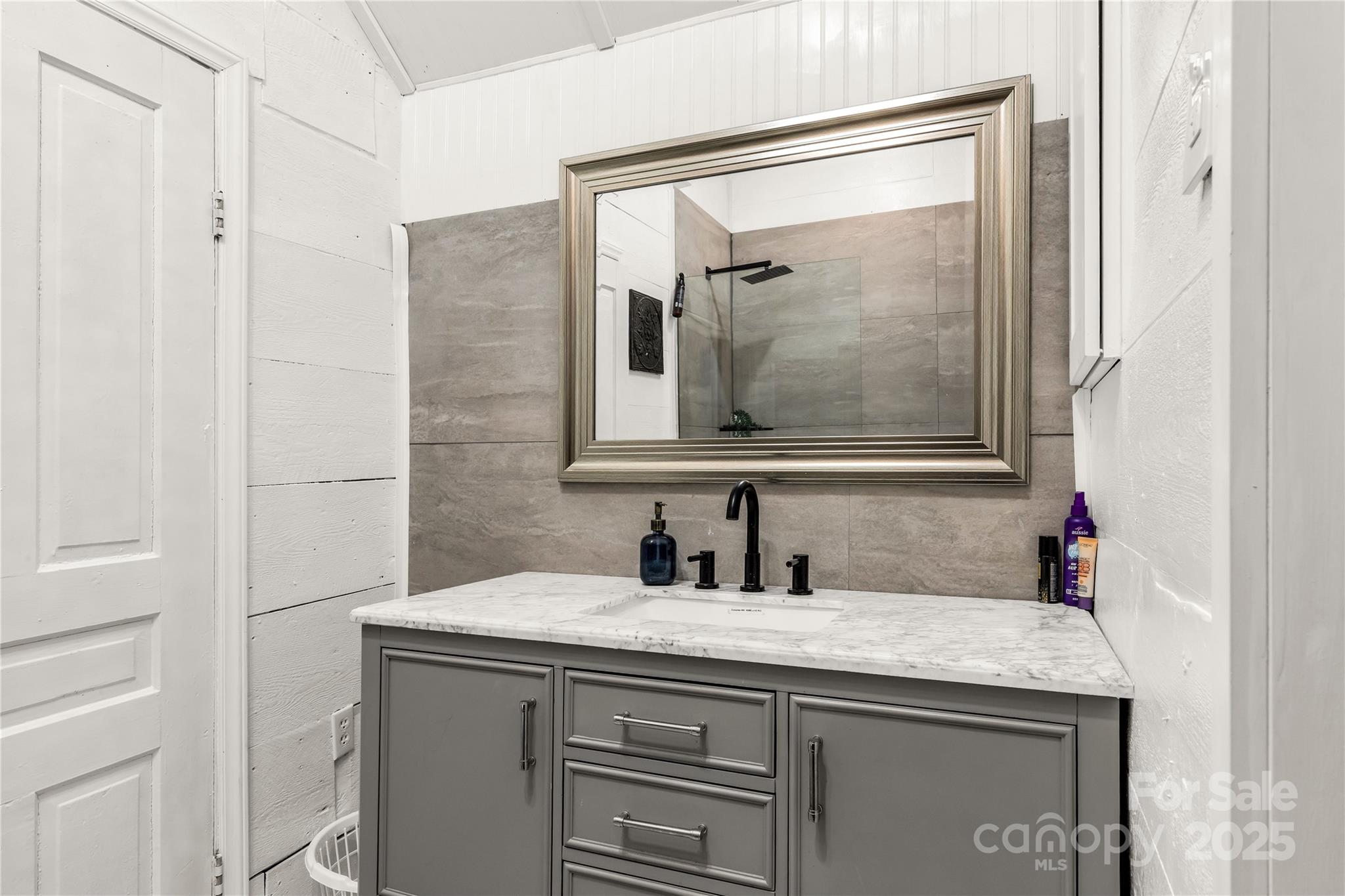 226 Liberty Street East York, SC 29745 - Photo 21 of 48 a bathroom with a granite countertop sink a mirror and a shower