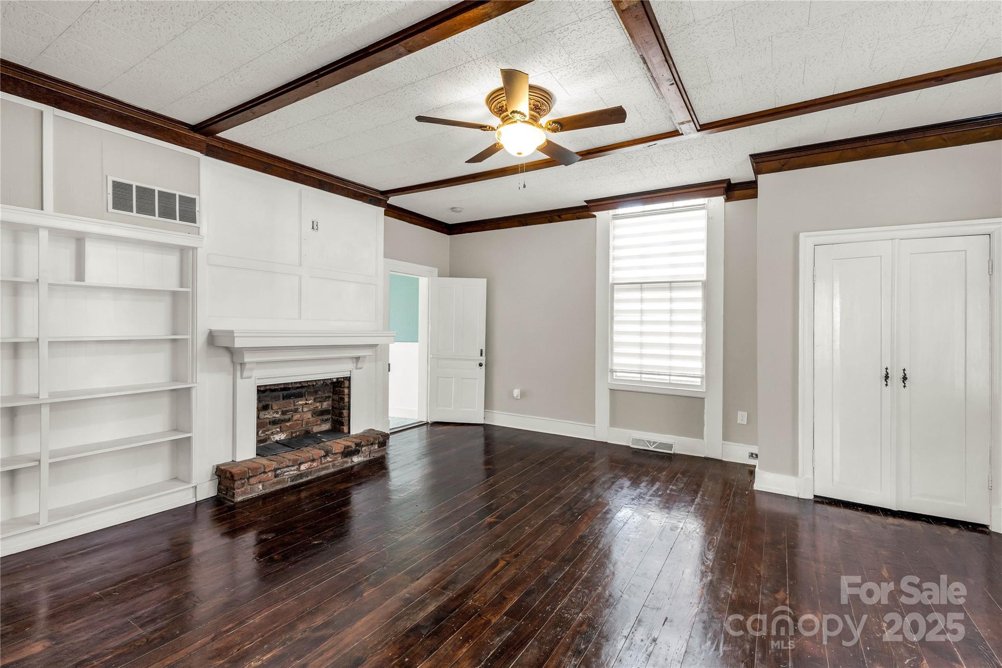 226 Liberty Street East York, SC 29745 - Photo 27 of 48 a living room with wooden floors and a fireplace