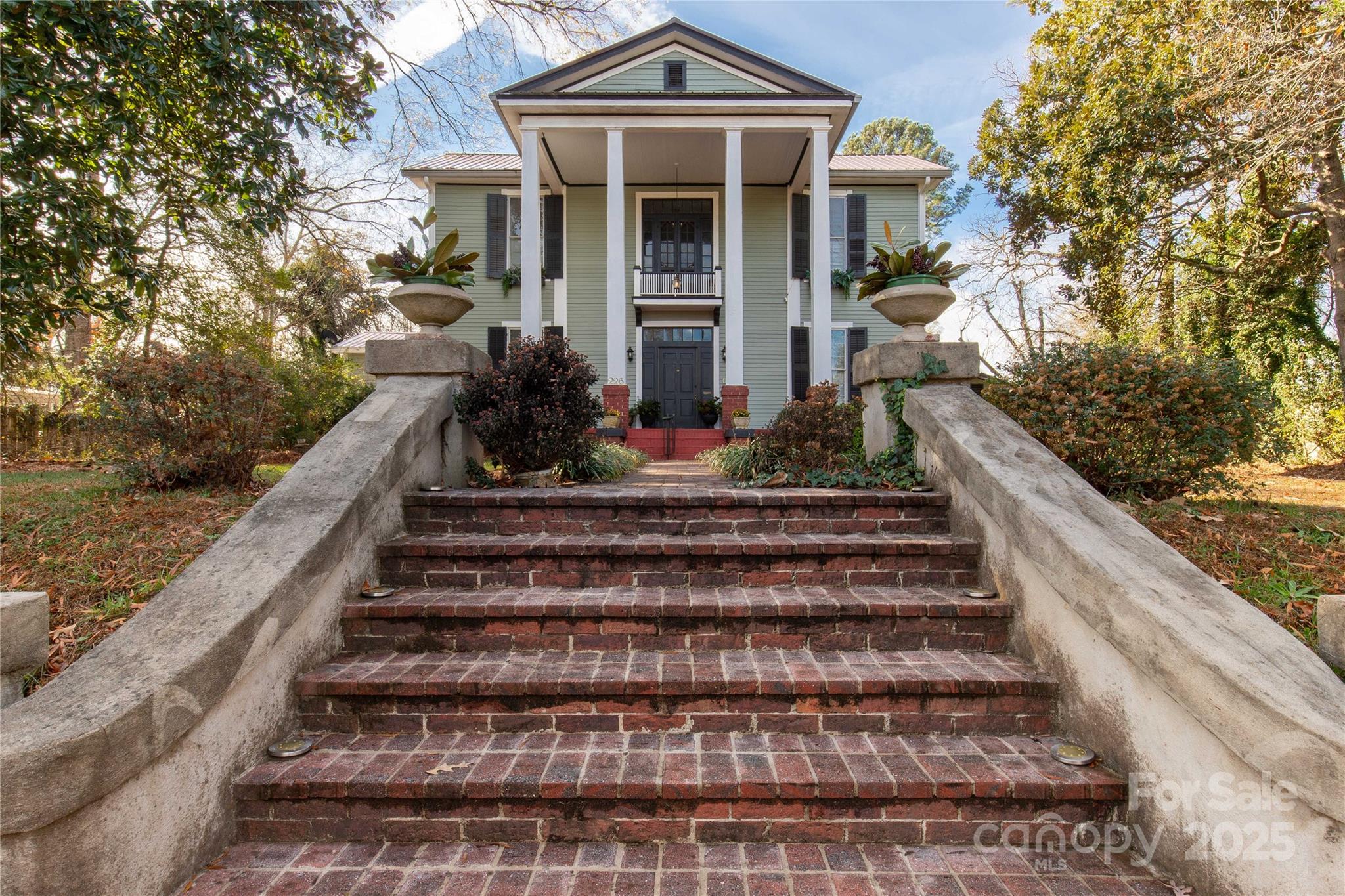 226 Liberty Street East York, SC 29745 - Photo 38 of 48 a view of a house with large windows and a flower garden